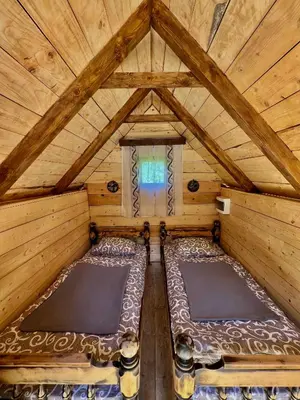 an overhead view of a wooden room with two beds at Vikendica,Bungalovi Lipska pećina in Cetinje