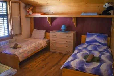 a bedroom with two beds and a dresser at Guest House Scepanovic in Sutomore