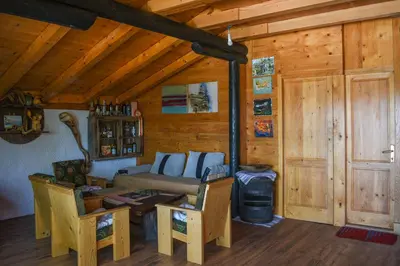 a living room with a couch in a wooden cabin at Guest House Scepanovic in Sutomore