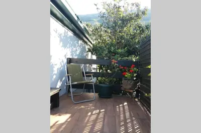 a balcony with potted plants and a table and chairs at Guest House Scepanovic in Sutomore