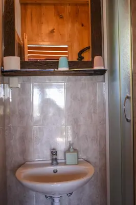 a bathroom with a sink and a mirror at Guest House Scepanovic in Sutomore