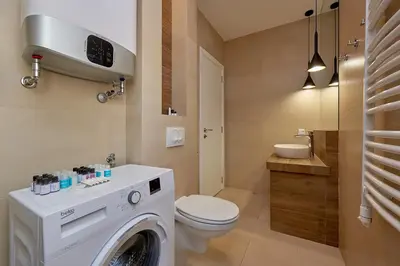 a bathroom with a washing machine and a toilet at BigMontenegro Dreams in Becici