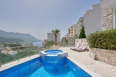 a blue swimming pool on the side of a building at BigMontenegro Dreams in Becici