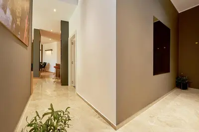 a hallway with a white wall and a plant at BigMontenegro Dreams in Becici