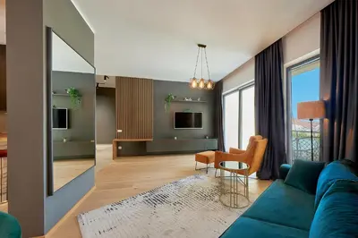 a living room with a blue couch and a table at BigMontenegro Dreams in Becici
