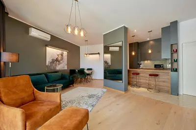 a living room with a couch and a kitchen at BigMontenegro Dreams in Becici