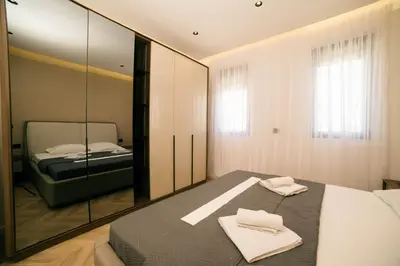 a bedroom with a bed and a mirror at B&B Lovac Hasa in Ulcinj