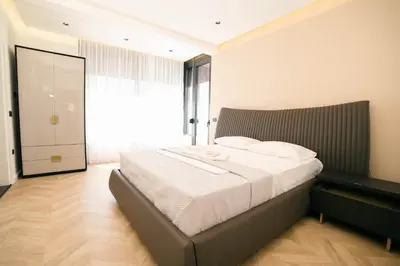 a bedroom with a large bed with a large window at B&B Lovac Hasa in Ulcinj
