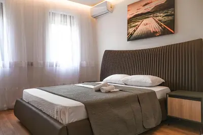 a bedroom with a bed with a teddy bear on it at B&B Lovac Hasa in Ulcinj