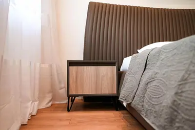 a night stand next to a bed in a bedroom at B&B Lovac Hasa in Ulcinj