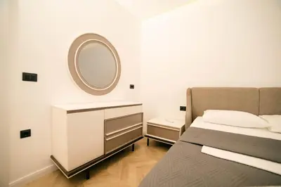 a bedroom with a bed and a mirror on the wall at B&B Lovac Hasa in Ulcinj