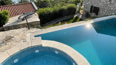 an overhead view of a large blue swimming pool at Mountains Villa near Budva in Budva