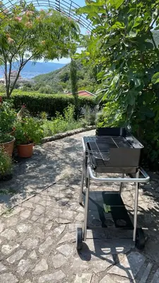 a barbecue grill sitting on a stone patio at Mountains Villa near Budva in Budva
