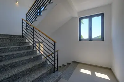 a staircase in a house with a window at Dubrave apartmani in Budva