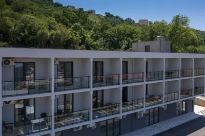 an aerial view of a building with a mountain in the background at Dubrave apartmani in Budva