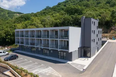 an aerial view of a building with a parking lot at Dubrave apartmani in Budva