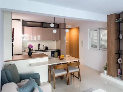 a kitchen and living room with a table and a couch at ChillOut apartment in Kotor Bay in Kotor