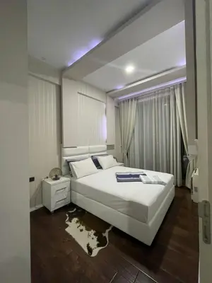a bedroom with a large white bed in a room at Luxury apartment in Victoria Palace Budva center in Budva
