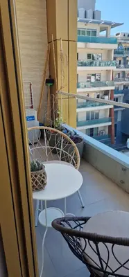 a balcony with tables and chairs on a building at Luxury apartment in Victoria Palace Budva center in Budva