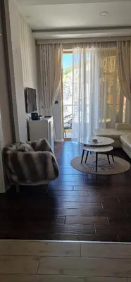 a living room with a couch and a coffee table at Luxury apartment in Victoria Palace Budva center in Budva