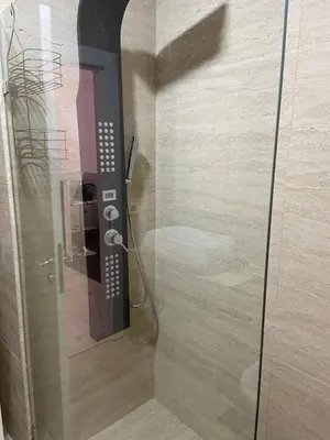a shower with a glass door in a bathroom at Luxury apartment in Victoria Palace Budva center in Budva