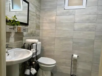 a bathroom with a toilet and a sink at W Apartments in Kotor