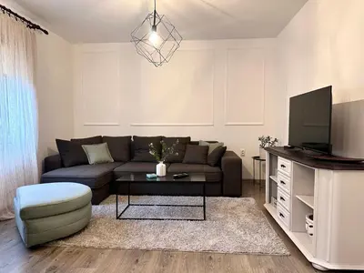a living room with a couch and a tv at W Apartments in Kotor