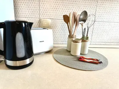 a kitchen counter with a coffee pot and utensils at W Apartments in Kotor