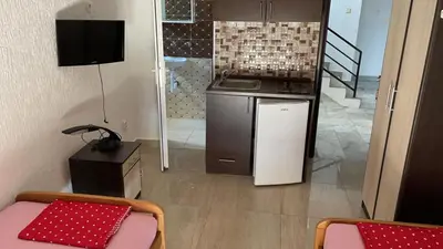 a small kitchen with a stove and a sink at Vila Marina in Sutomore