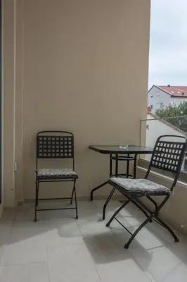 two chairs and a table on a balcony at Apartments Milica in Becici