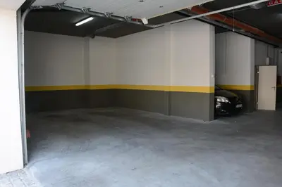 an empty garage with a yellow and white wall at Apartments Milica in Becici