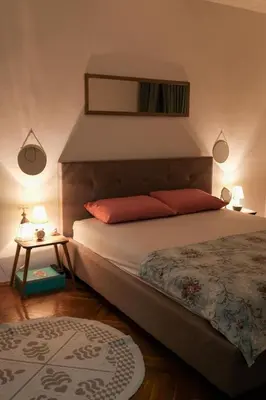 a bedroom with a bed and a mirror on the wall at Ivana in Rijeka Crnojevića