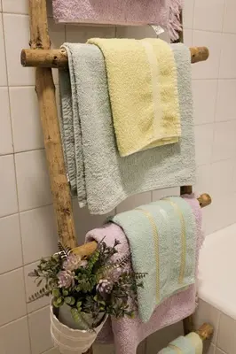 a bunch of towels on a rack in a bathroom at Ivana in Rijeka Crnojevića