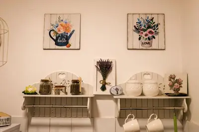a room with two shelves with flowers and vases at Ivana in Rijeka Crnojevića