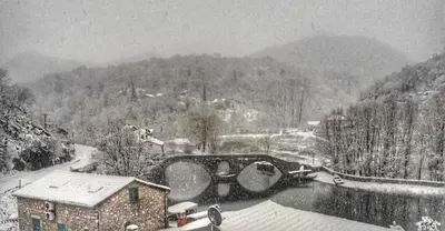 a black and white photo of a snow covered village at Ivana in Rijeka Crnojevića