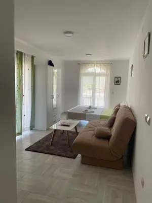 a living room with a couch and a bed at Luna Apartments in Budva