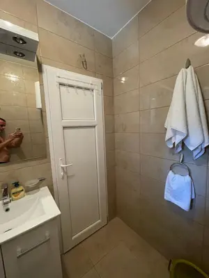 a bathroom with a white door and a sink at Luna Apartments in Budva