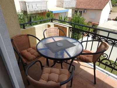 a glass table and chairs on a balcony at Luna Apartments in Budva