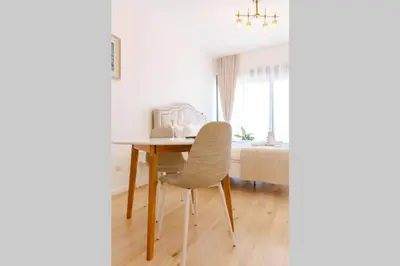 a dining room table with a chair and a bed at Delightful Studio Soho City in Bar