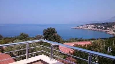 a balcony of a house with a view of the water at MonoLiza in Utjeha