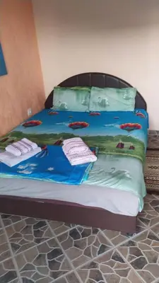 a bed in a room with towels on it at MonoLiza in Utjeha