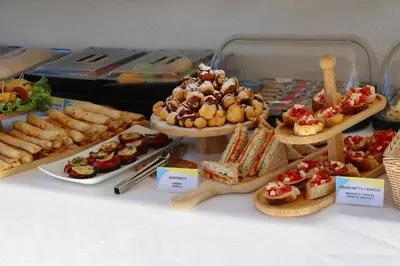 a table filled with different types of food on plates at Atelier in Ulcinj