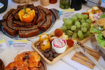 a table topped with different types of bread and fruit at Atelier in Ulcinj