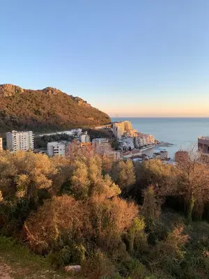 a view of a city and the ocean from a hill at Apartments GC 3 in Rafailovici