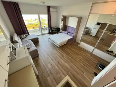 a large living room with a bed and a couch at Apartments GC 3 in Rafailovici
