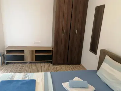a bedroom with a bed and a dresser and a cabinet at Apartments Željka-Dobrota in Kotor