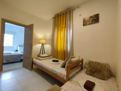 a small bedroom with a bed and a mirror at Apartments Željka-Dobrota in Kotor