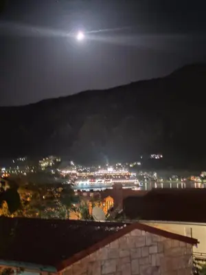 a full moon over a city at night at Apartments Željka-Dobrota in Kotor