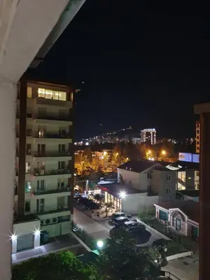 a city at night with cars parked in a parking lot at Vesna Studio Apartman in Budva