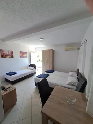 a living room with two beds and a table at Apartmani Čavor in Budva